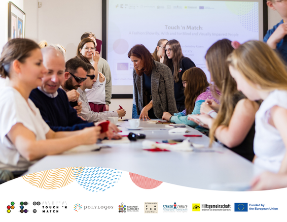 Participants of the Touch’n Match project workshop talk and work with tactile materials, with a presentation screen visible in the background.